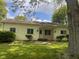 Charming single-story home featuring a landscaped front yard and light yellow siding at 208 Winding Dr, Alexandria, IN 46001