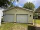 Detached two-car garage with traditional white doors and light fixtures at 208 Winding Dr, Alexandria, IN 46001