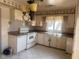 Retro kitchen with white cabinets and outdated appliances at 208 Winding Dr, Alexandria, IN 46001
