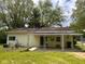 Back of house with large patio and awning at 208 Winding Dr, Alexandria, IN 46001