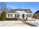 Charming white house with black shutters and snowy yard at 2109 California St, Columbus, IN 47201