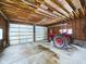 Empty garage with double doors and a vintage tractor inside at 2584 W Mercer Ln, Pendleton, IN 46064