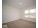 An empty bedroom with plush carpeting and a view of the outside at 3231 W Keepsake Ln, Monrovia, IN 46157
