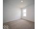 An empty bedroom with plush carpeting and a single window for natural light at 3231 W Keepsake Ln, Monrovia, IN 46157