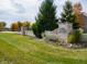 Stone entrance to the community with white fencing and manicured landscaping at 3231 W Keepsake Ln, Monrovia, IN 46157