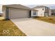 A view of the home's ample concrete driveway leading up to an attached two-car garage at 3231 W Keepsake Ln, Monrovia, IN 46157
