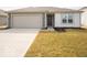 A charming single-story home featuring a two-car garage and well-manicured lawn at 3231 W Keepsake Ln, Monrovia, IN 46157