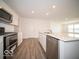 Bright kitchen features stainless appliances, large island with sink and quartz countertop at 3231 W Keepsake Ln, Monrovia, IN 46157