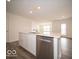 Bright kitchen features a large island with sink, shaker cabinets and stainless dishwasher at 3231 W Keepsake Ln, Monrovia, IN 46157