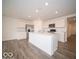 Bright kitchen features a stainless steel refrigerator and large island with sink and dishwasher at 3231 W Keepsake Ln, Monrovia, IN 46157