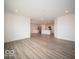 Open-concept living space flows into a bright kitchen with sleek, stainless steel appliances at 3231 W Keepsake Ln, Monrovia, IN 46157