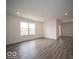 Spacious living area features durable floors, recessed lighting, and a large window at 3231 W Keepsake Ln, Monrovia, IN 46157
