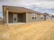 View of the home's back exterior featuring a covered patio and simple, clean siding and window design at 3231 W Keepsake Ln, Monrovia, IN 46157