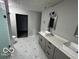 Modern bathroom with double vanity and geometric tile floor at 334 Hamilton Ave, Indianapolis, IN 46201