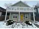 Charming two-story home with a yellow door and balcony at 334 Hamilton Ave, Indianapolis, IN 46201
