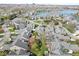 Aerial perspective of a community with gray-roofed homes, mature trees, and well-maintained lawns at 3543 Clearwater Cir, Indianapolis, IN 46240