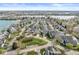 Scenic aerial view of gray-roofed homes in a well-maintained community, with lush green spaces and easy access to a serene lake at 3543 Clearwater Cir, Indianapolis, IN 46240