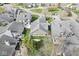 Overhead shot of a well-kept home featuring a gray roof, green lawn, and mature trees in a desirable location at 3543 Clearwater Cir, Indianapolis, IN 46240