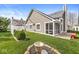 Well-maintained backyard with a screened-in porch, lush lawn, and a quaint patio area perfect for outdoor relaxation at 3543 Clearwater Cir, Indianapolis, IN 46240