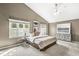 Spacious bedroom featuring vaulted ceilings, neutral walls, carpet floors, and large windows at 3543 Clearwater Cir, Indianapolis, IN 46240