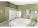 Green bedroom with ensuite access and large closet at 3543 Clearwater Cir, Indianapolis, IN 46240