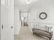 Spacious entryway with tiled flooring, a cozy bench, and a decorative mirror leading to various areas of the home at 3543 Clearwater Cir, Indianapolis, IN 46240
