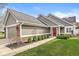 Charming home featuring a red front door, manicured lawn, neutral siding, and a brick accent for a welcoming curb appeal at 3543 Clearwater Cir, Indianapolis, IN 46240