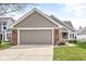 Attractive home with a spacious two-car garage, brick accents, well-kept lawn, and inviting curb appeal at 3543 Clearwater Cir, Indianapolis, IN 46240