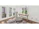 Bright home office with natural light, a cozy chair, a wooden desk, and hardwood floors at 3543 Clearwater Cir, Indianapolis, IN 46240