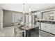 Stylish kitchen featuring granite countertops, white cabinetry, and a center island with seating, perfect for entertaining at 3543 Clearwater Cir, Indianapolis, IN 46240