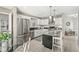 Modern kitchen with stainless steel appliances, granite countertops, white cabinets, and a cozy breakfast bar area at 3543 Clearwater Cir, Indianapolis, IN 46240