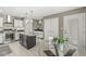 This bright kitchen features stainless steel appliances, granite counters, an island and a cozy breakfast nook at 3543 Clearwater Cir, Indianapolis, IN 46240