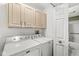 Laundry area featuring side-by-side washer and dryer along with upper cabinets for storage at 3543 Clearwater Cir, Indianapolis, IN 46240