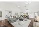 Spacious living room with vaulted ceilings, hardwood floors, and a gray sectional for a cozy retreat at 3543 Clearwater Cir, Indianapolis, IN 46240