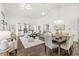 Open-concept living and dining area featuring hardwood floors, vaulted ceilings, and generous natural light at 3543 Clearwater Cir, Indianapolis, IN 46240
