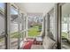 Relaxing screened porch with cozy seating and views of the landscaped backyard and lush greenery at 3543 Clearwater Cir, Indianapolis, IN 46240