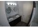 Double vanity bathroom with gray countertop and oval mirrors at 3608 N Kenwood Ave, Indianapolis, IN 46208