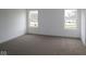 A bright bedroom with carpet and two windows at 3945 Highcrest Rd, Indianapolis, IN 46239