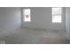 Bright bedroom with two large windows and unfinished wood flooring at 3945 Highcrest Rd, Indianapolis, IN 46239