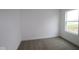 Simple bedroom with plush carpeting, neutral walls, and a bright window view at 3945 Highcrest Rd, Indianapolis, IN 46239