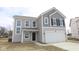 Charming two-story home showcasing a two-car garage and appealing gray siding at 3945 Highcrest Rd, Indianapolis, IN 46239