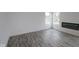Bright living room featuring modern fireplace, gray wood floors, and white walls at 3945 Highcrest Rd, Indianapolis, IN 46239