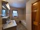 Bathroom with tiled walls, vanity, and bathtub at 407 Hawthorne Ln, Greenfield, IN 46140