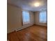 Spacious bedroom featuring hardwood floors and two windows at 407 Hawthorne Ln, Greenfield, IN 46140