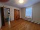 Well-lit bedroom with hardwood floors and access to another room at 407 Hawthorne Ln, Greenfield, IN 46140