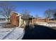 Side view of brick ranch house with attached garage and snowy yard at 407 Hawthorne Ln, Greenfield, IN 46140