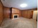 Cozy Gathering room with wood paneled walls and a fireplace at 407 Hawthorne Ln, Greenfield, IN 46140