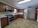 Kitchen with stainless steel appliances and tile floor at 407 Hawthorne Ln, Greenfield, IN 46140