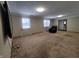 Spacious living room featuring neutral carpeting and large windows at 407 Hawthorne Ln, Greenfield, IN 46140