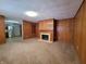 Living room with wood paneled walls and a fireplace at 407 Hawthorne Ln, Greenfield, IN 46140